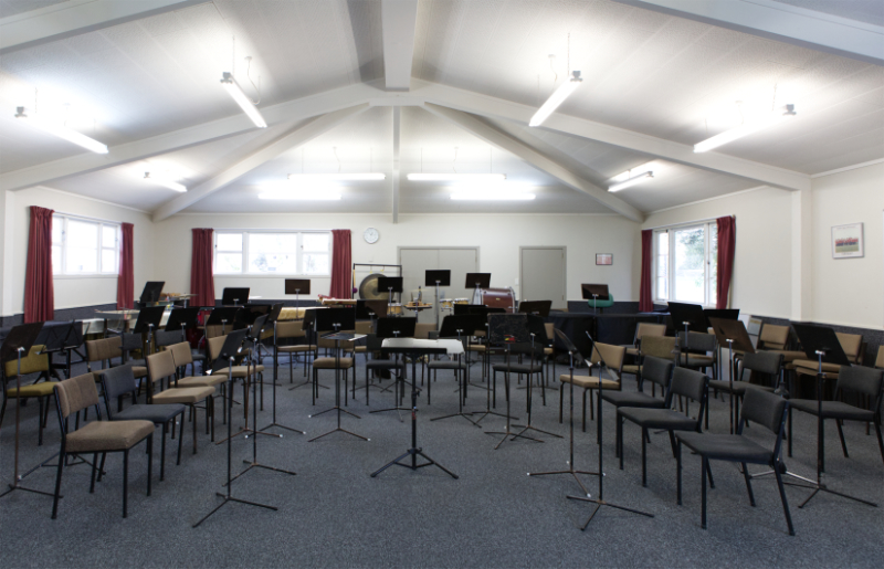 Interior photo of seats and music stands set up in a U 